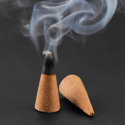 A Dhoop Cone burning and another lying down